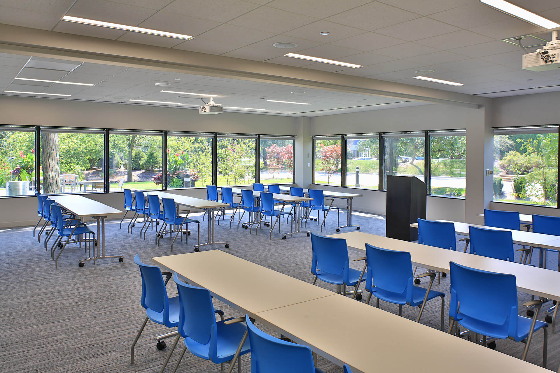 Conference Room with multiple tables and chairs inside Bannockburn Lakes building