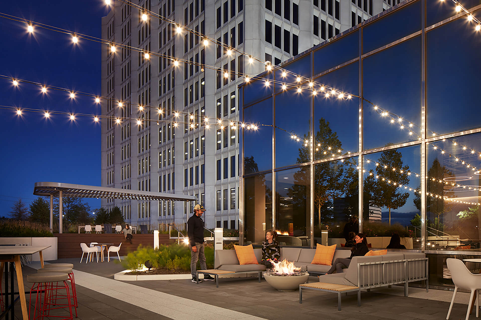 An outdoor patio area at Continental Towers with string lights and a fire pit.