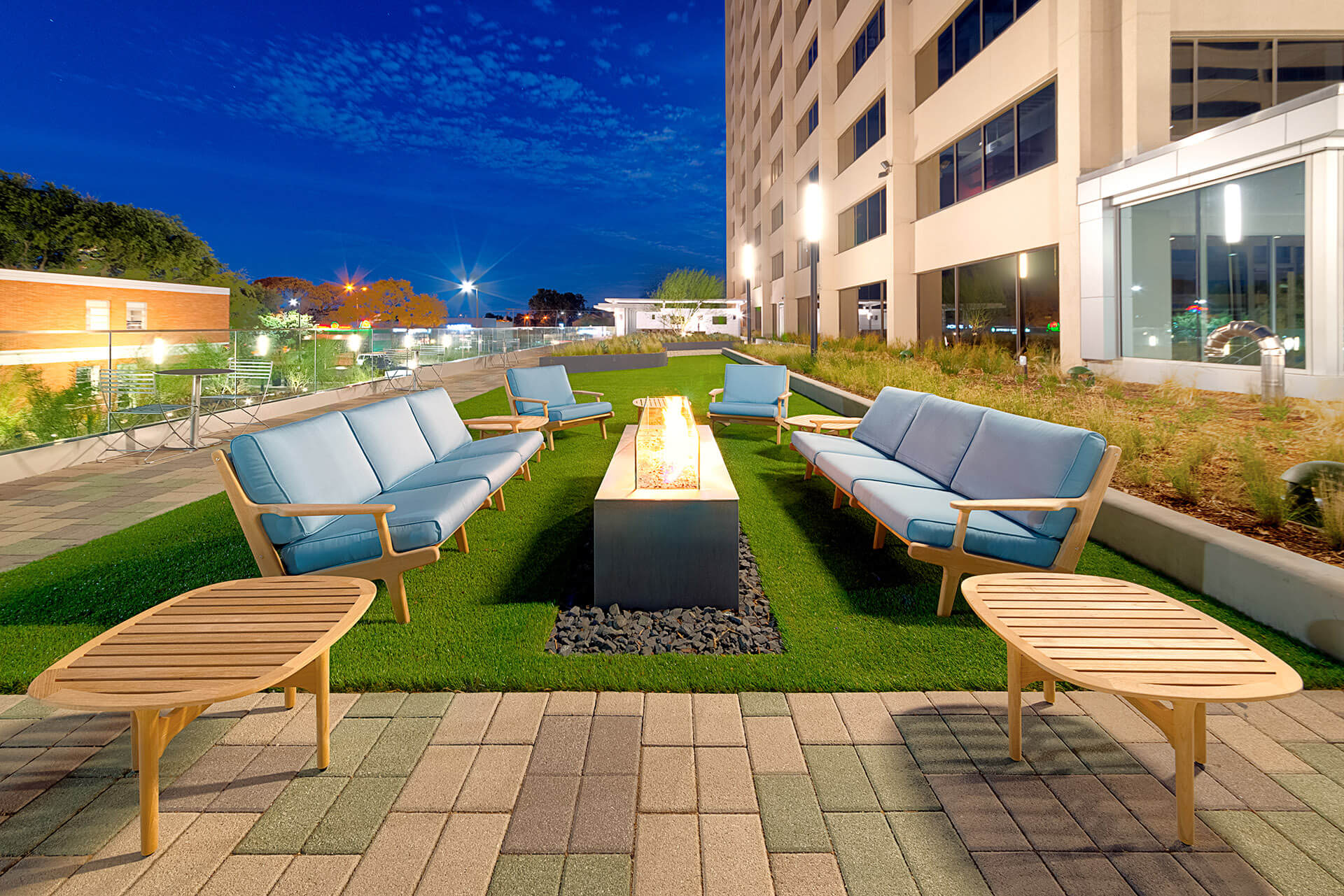 outdoor patio area with couches and firepit at Energy Square
