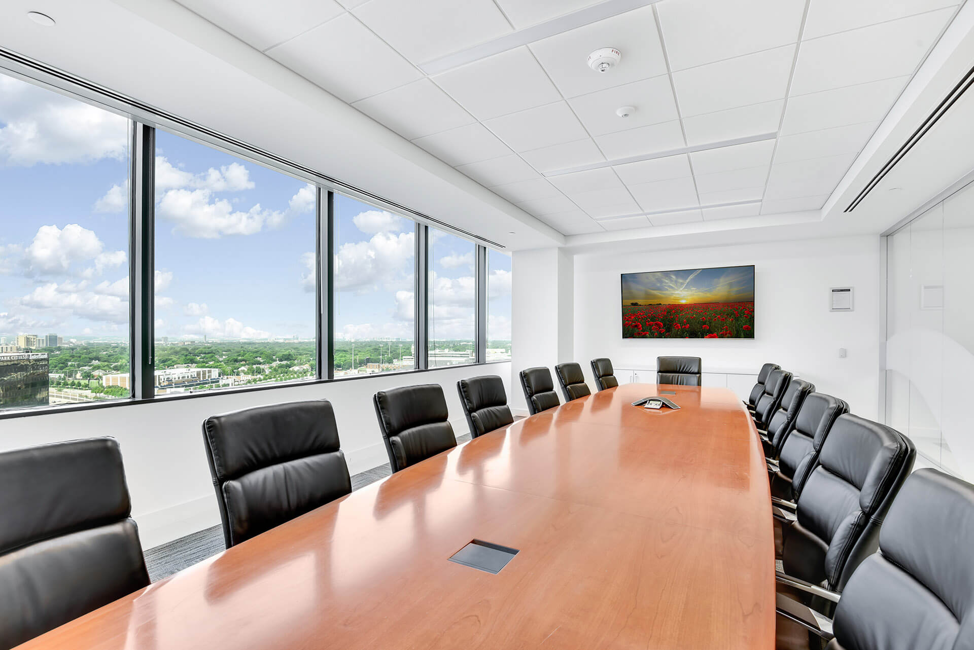 long conference room table with tv at Premier Place Dallas