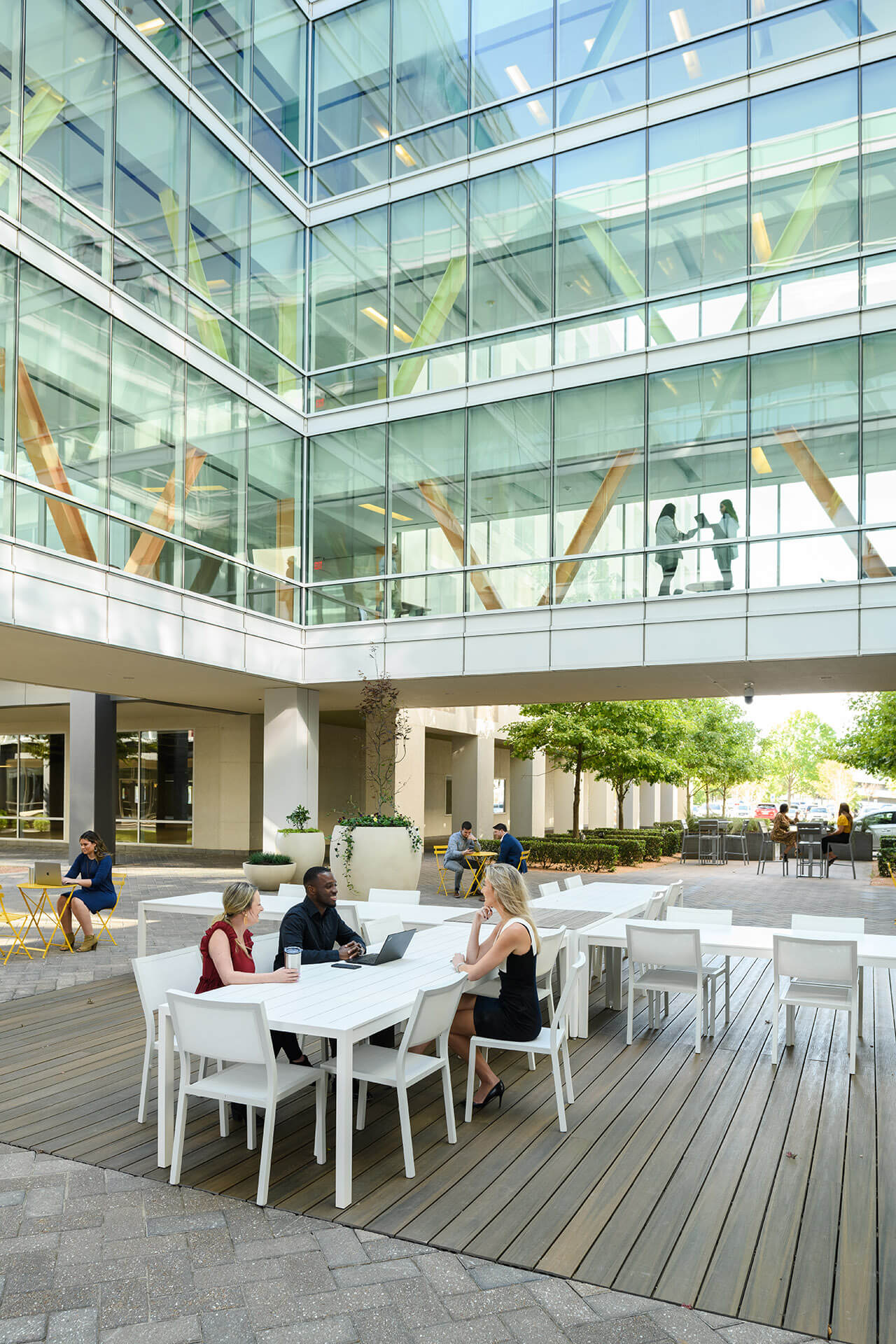 outdoor atrium area with business people sitting at tables and chairs at the terraces